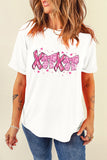 Person wearing a white t-shirt with pink graphics and text on a beige background